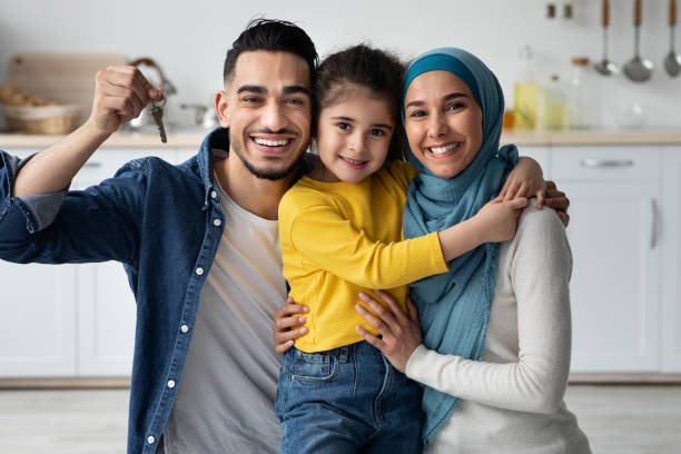 Family holding the keys to their new home